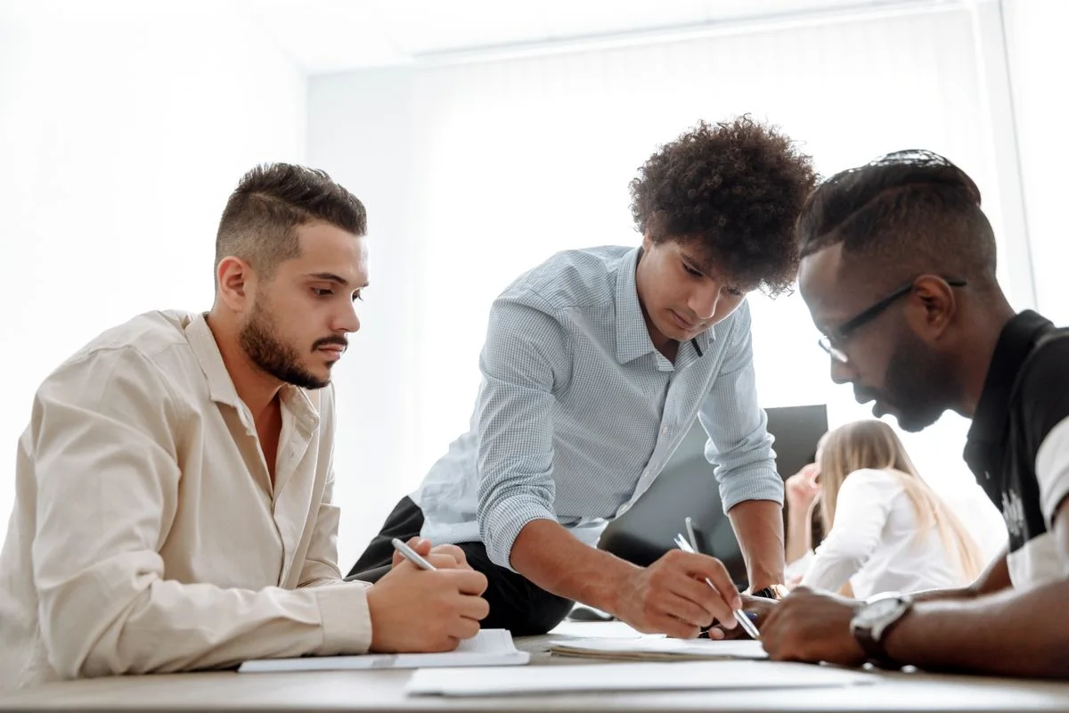Colleagues working together at a table in a shared office