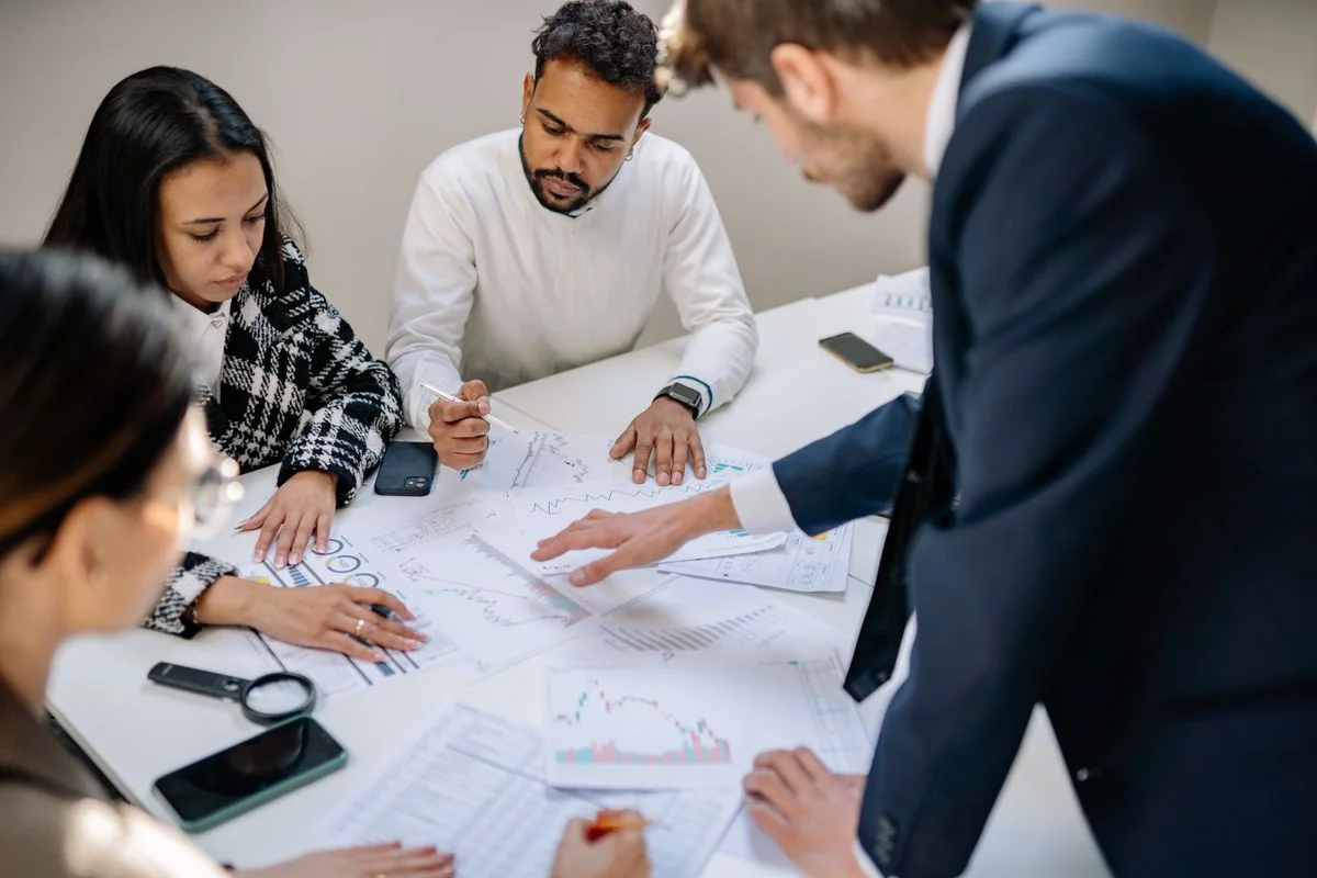Business team reviewing documents together around a meeting table